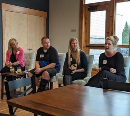 Panelists from the 2024 United Way Emerging Leaders Entrepreneur Sip event sit before attendees answering questions.