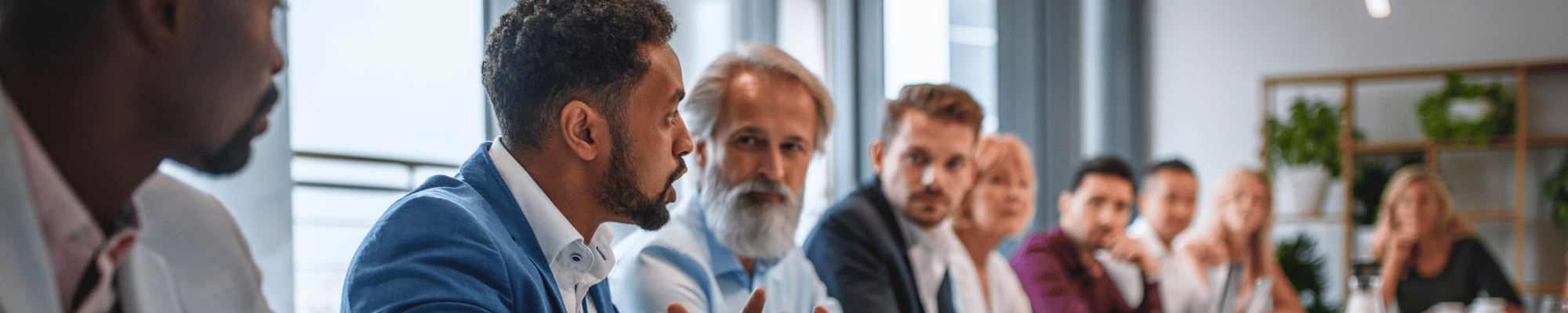 Group of diverse business leaders around a table.