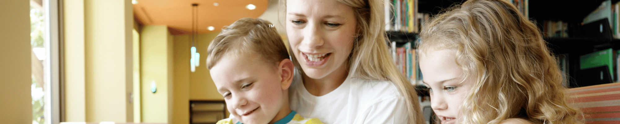 Image of a mother reading two her two children.