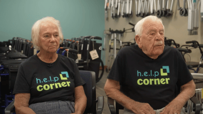 Elderly couple pictured in front of durable medical equipment.