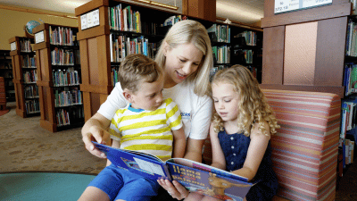 Image of a mother reading two her two children.