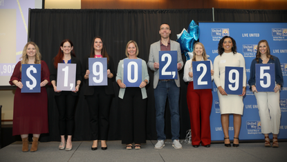 United Way Campaign Chairs, Emerging Leaders and staff display the total amount of money raised for the 2025 campaign.
